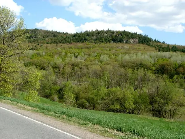 Mont Rigaud’s wooded slopes seen from the surrounding countryside.