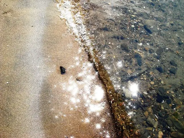 Sunlight on the shallow shoreline at Saint-Zotique beach.